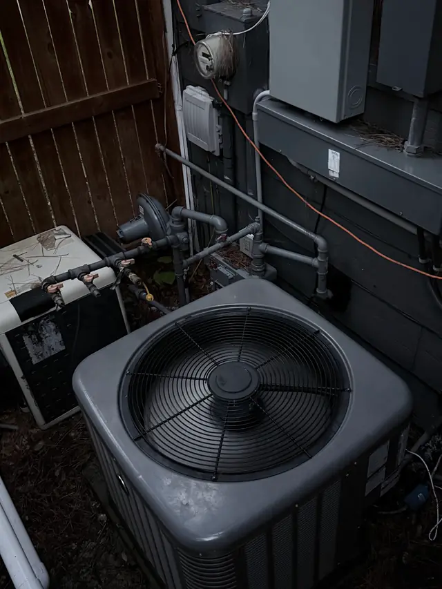 Condenser set in a tight side yard beside pool equipment