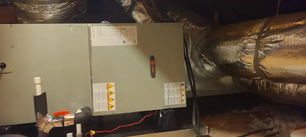 Air handler installed in an attic with insulated ductwork