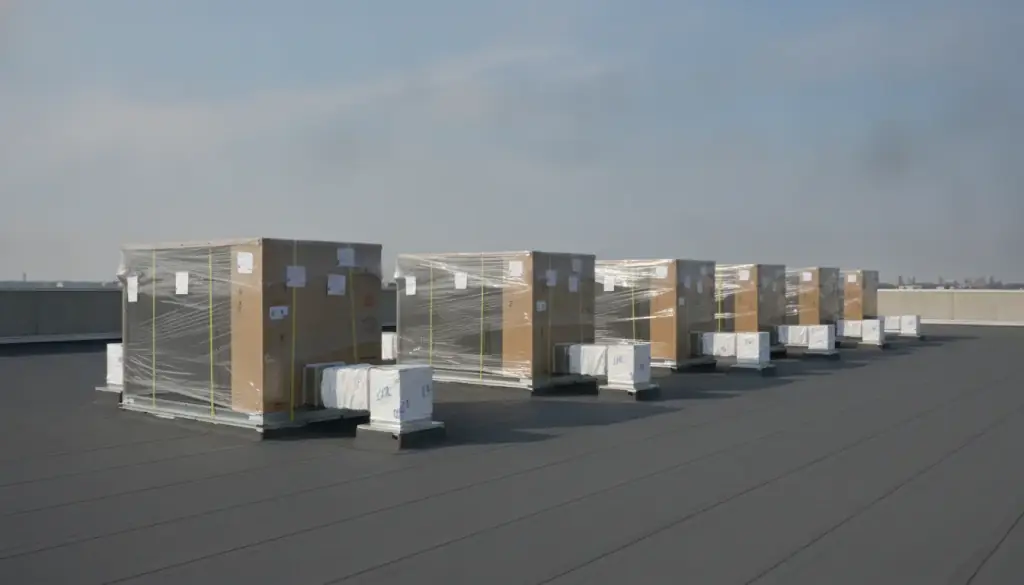 Packaged rooftop units lined up on a flat commercial roof